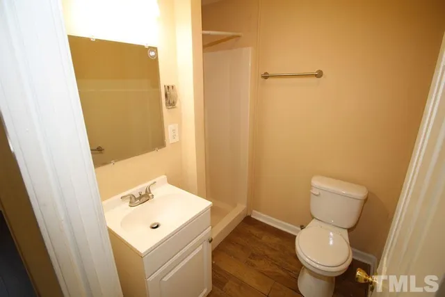 a white toilet sitting next to a bathroom sink
