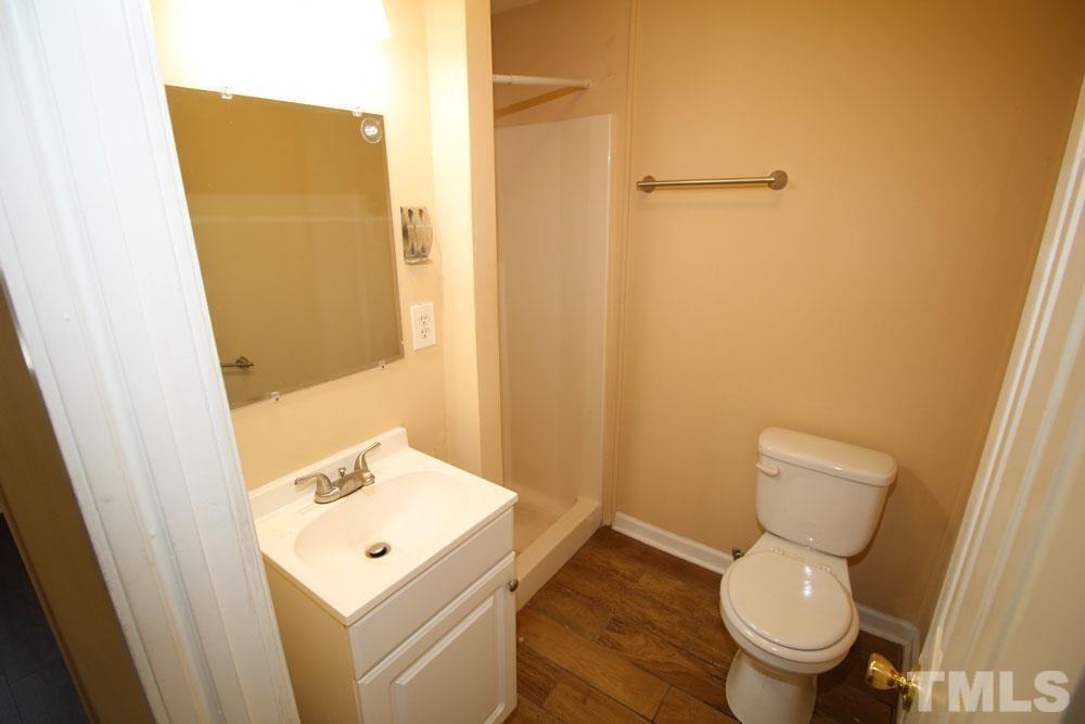 110 Emory Street Garner, NC 27529 - Photo 13 of 22 a white toilet sitting next to a bathroom sink