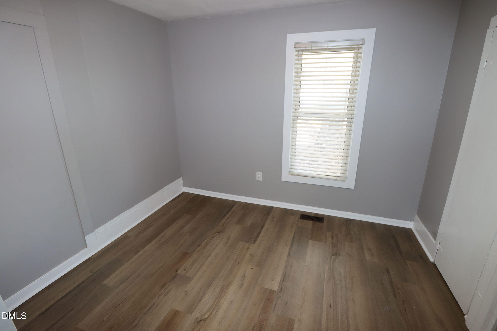 110 Emory Street Garner, NC 27529 - Photo 14 of 22 an empty room with wooden floor and windows