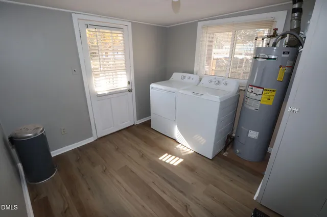 a utility room with wooden floor washer and dryer