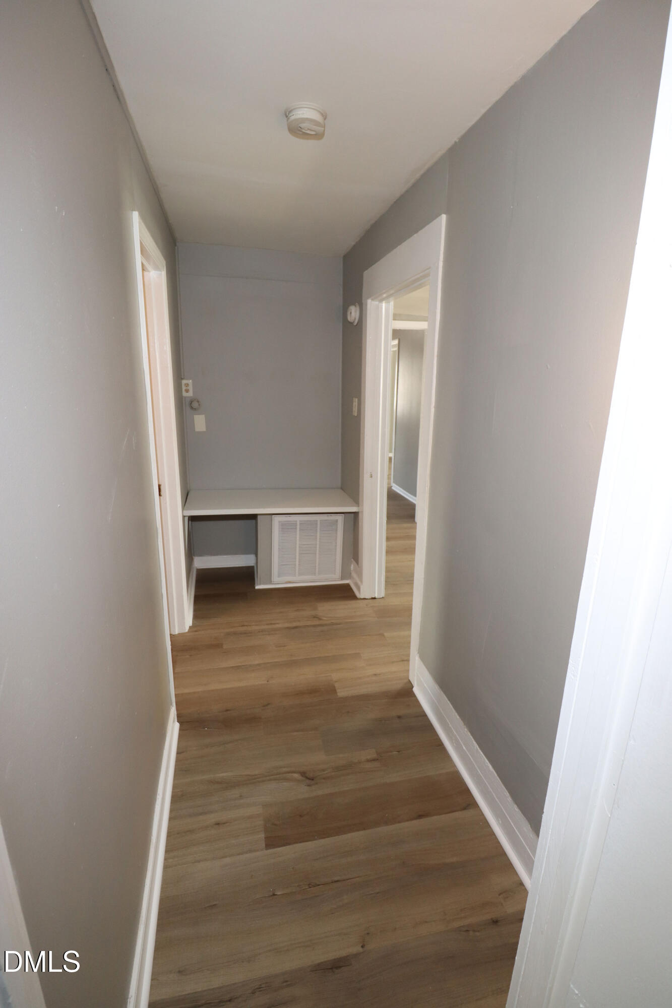 110 Emory Street Garner, NC 27529 - Photo 16 of 22 a view of an empty room with wooden floor and stairs