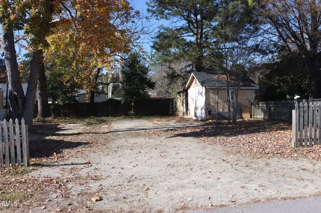 a front view of a house with a yard covered in snow