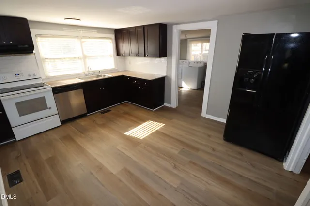 a kitchen with granite countertop a refrigerator and a stove