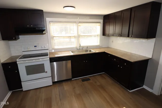 a kitchen with a sink and a stove top oven