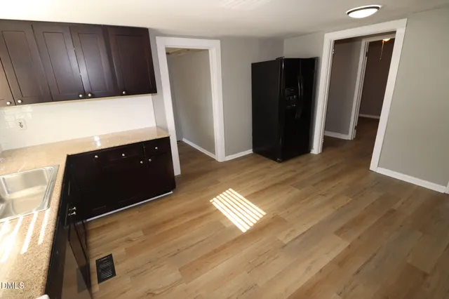 a view of kitchen with refrigerator and window