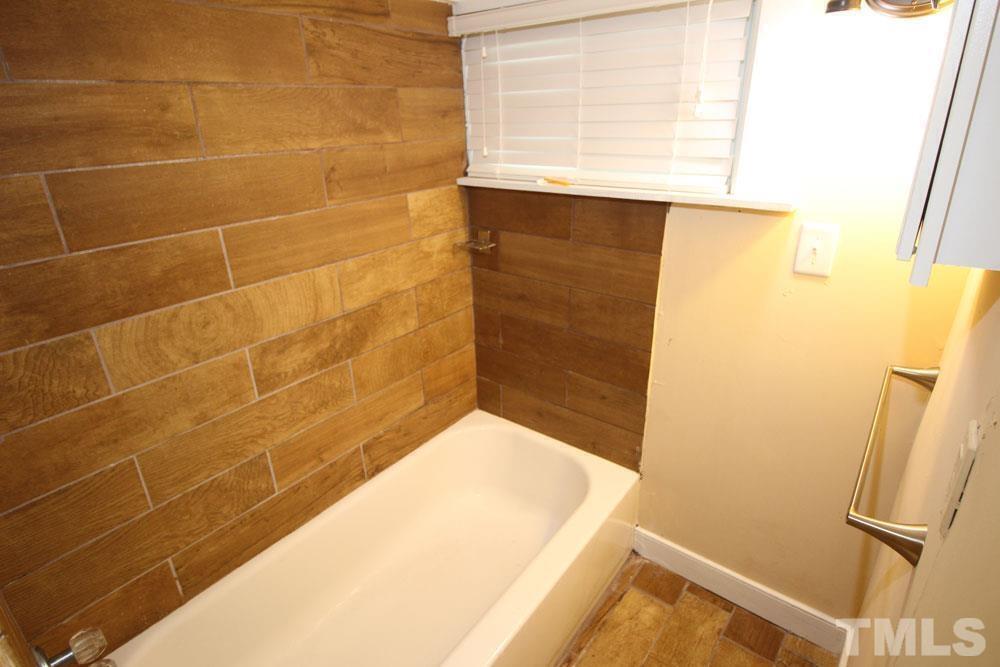 110 Emory Street Garner, NC 27529 - Photo 10 of 22 a bathroom with a tub and a shower