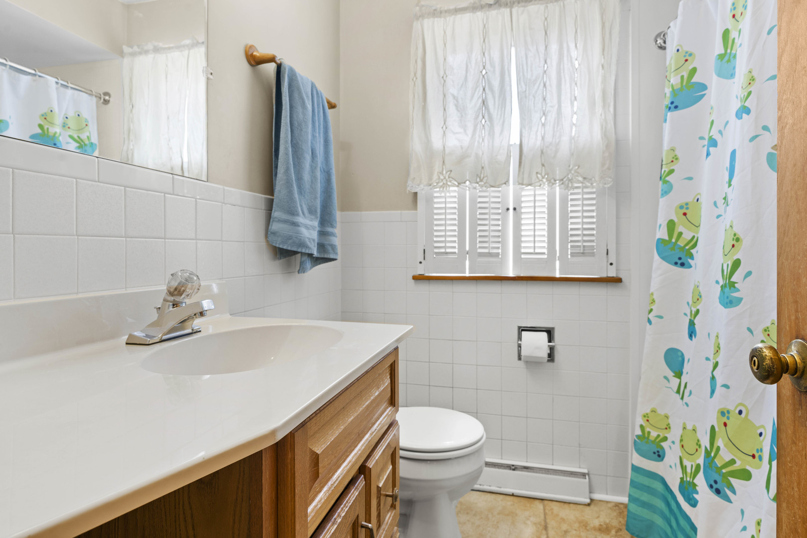 18335 Riegel Road Homewood, IL 60430 - Photo 14 of 23 a bathroom with a sink a toilet and a shower curtain