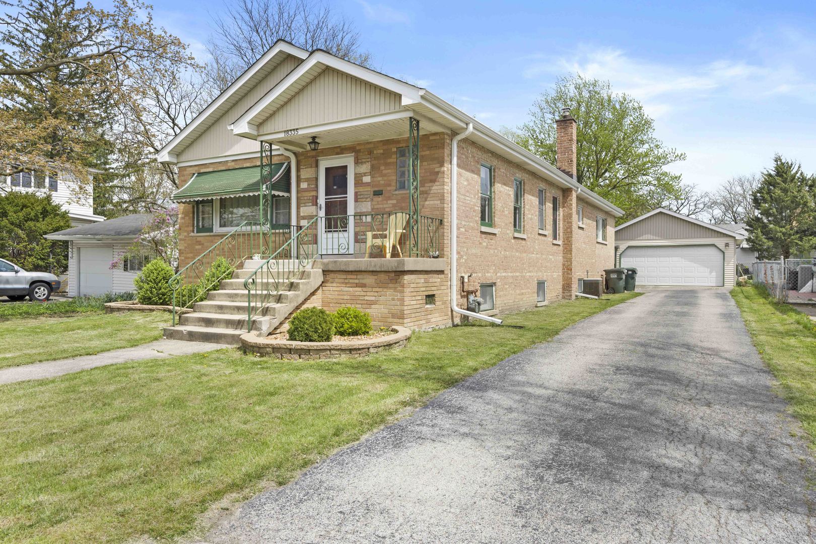 18335 Riegel Road Homewood, IL 60430 - Photo 2 of 23 a front view of a house with a yard and potted plants