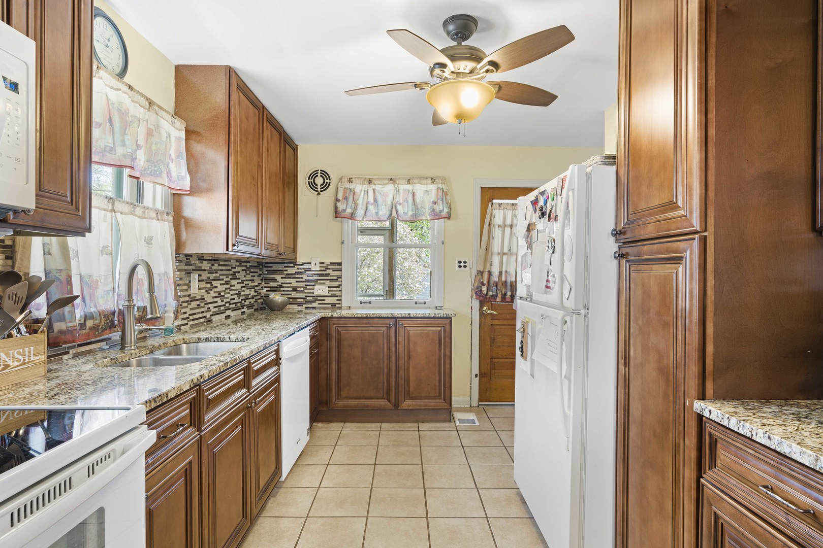 18335 Riegel Road Homewood, IL 60430 - Photo 10 of 23 a kitchen with a refrigerator a sink and cabinets