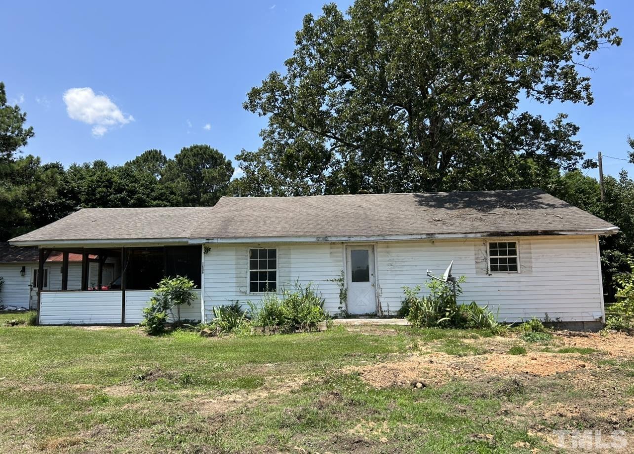 1372 Frazier Road Spring Hope, NC 27882 - Photo 1 of 6 a front view of a house with a garden