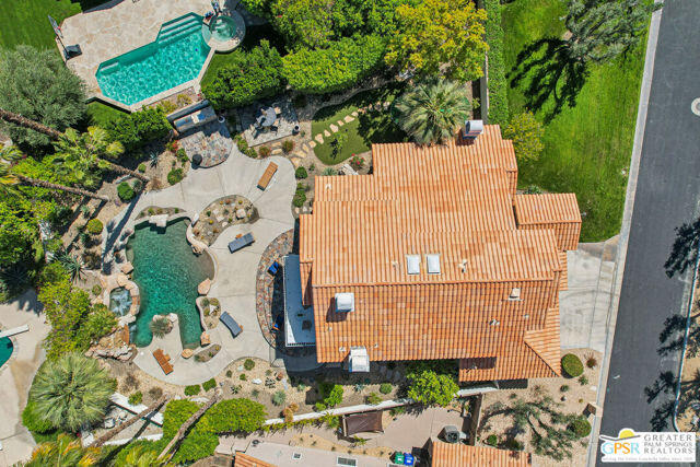 364 Oakmont Drive Palm Desert, CA 92211 - Photo 15 of 74 an aerial view of a house with a yard and garden in front of it