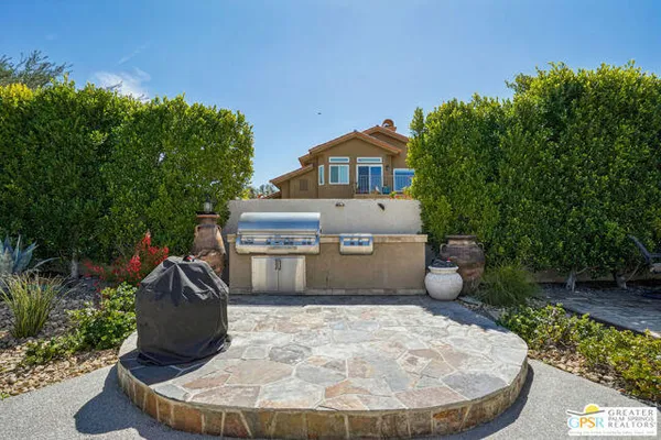 a view of a patio with a table and chairs