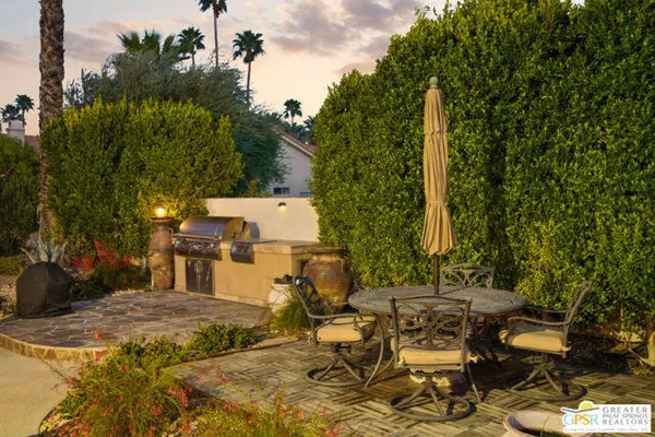 a living room with furniture a fireplace and a large window