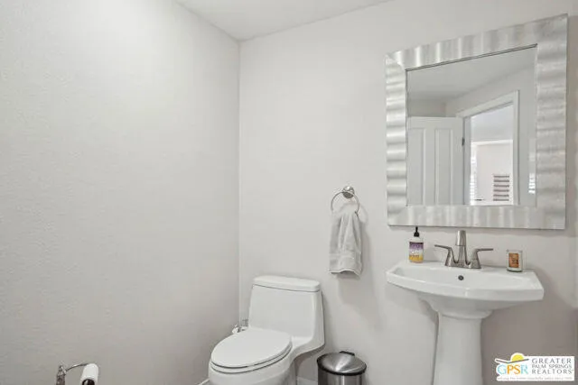 a living room with furniture and a view of kitchen