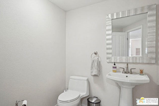 364 Oakmont Drive Palm Desert, CA 92211 - Photo 31 of 74 a bathroom with a sink a toilet and mirror