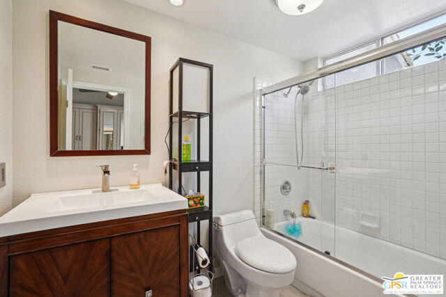 364 Oakmont Drive Palm Desert, CA 92211 - Photo 35 of 74 a bathroom with a sink a toilet a mirror and shower