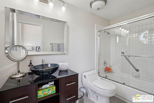 364 Oakmont Drive Palm Desert, CA 92211 - Photo 38 of 74 a bathroom with a granite countertop toilet sink and mirror