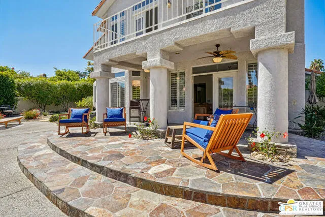 a view of a chairs and table in patio with a lake view