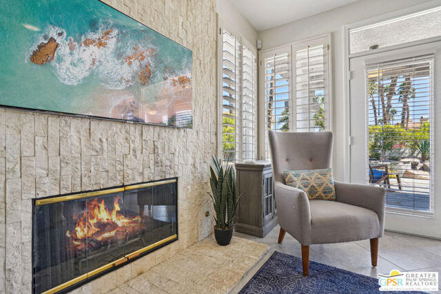 364 Oakmont Drive Palm Desert, CA 92211 - Photo 45 of 74 a living room with furniture a fireplace and a large window