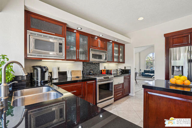 364 Oakmont Drive Palm Desert, CA 92211 - Photo 54 of 74 a kitchen with stainless steel appliances granite countertop a stove and cabinets