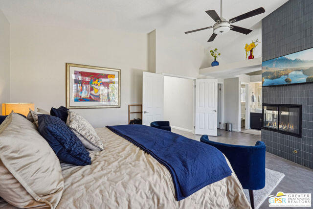 364 Oakmont Drive Palm Desert, CA 92211 - Photo 56 of 74 a bedroom with a bed and a chandelier