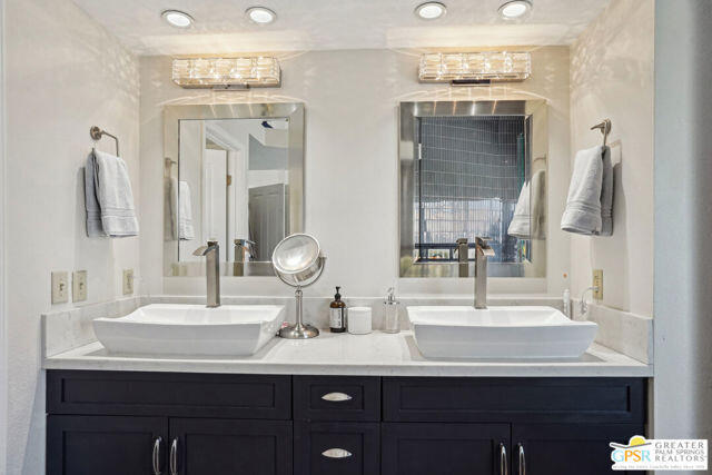 364 Oakmont Drive Palm Desert, CA 92211 - Photo 57 of 74 a bathroom with a double vanity sink and a mirror