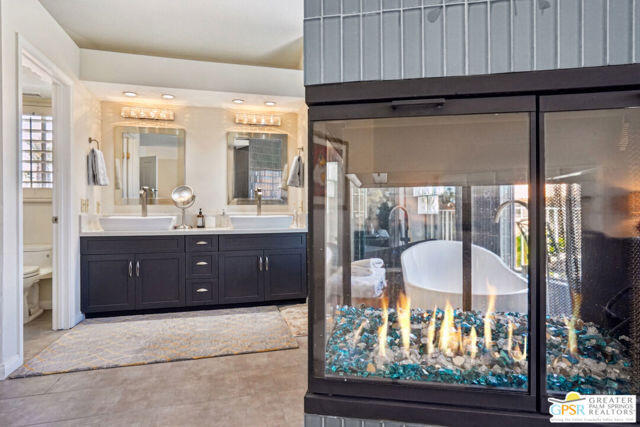 364 Oakmont Drive Palm Desert, CA 92211 - Photo 58 of 74 a bathroom with a sink a mirror and a shower