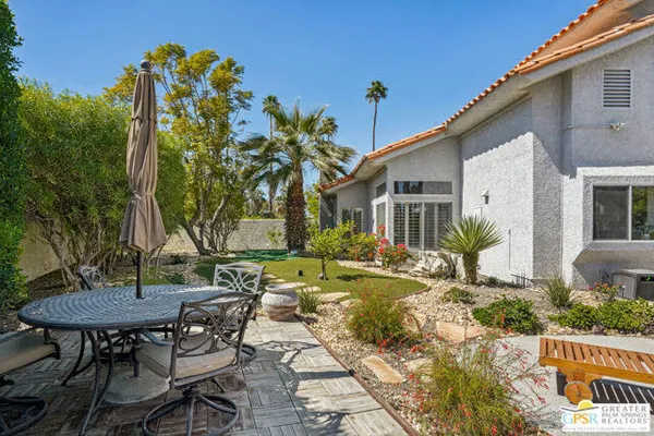 an aerial view of a house with yard and garden