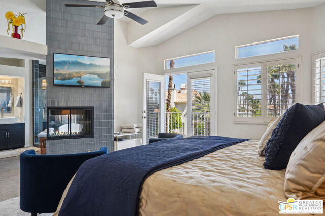 364 Oakmont Drive Palm Desert, CA 92211 - Photo 65 of 74 a bedroom with a bed and a fireplace