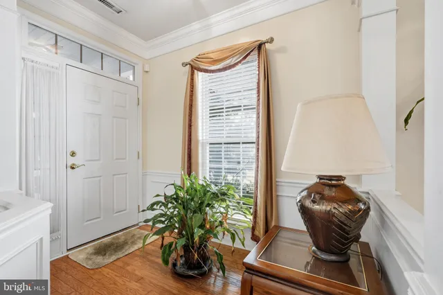 a view of a dining room with furniture and a chandelier