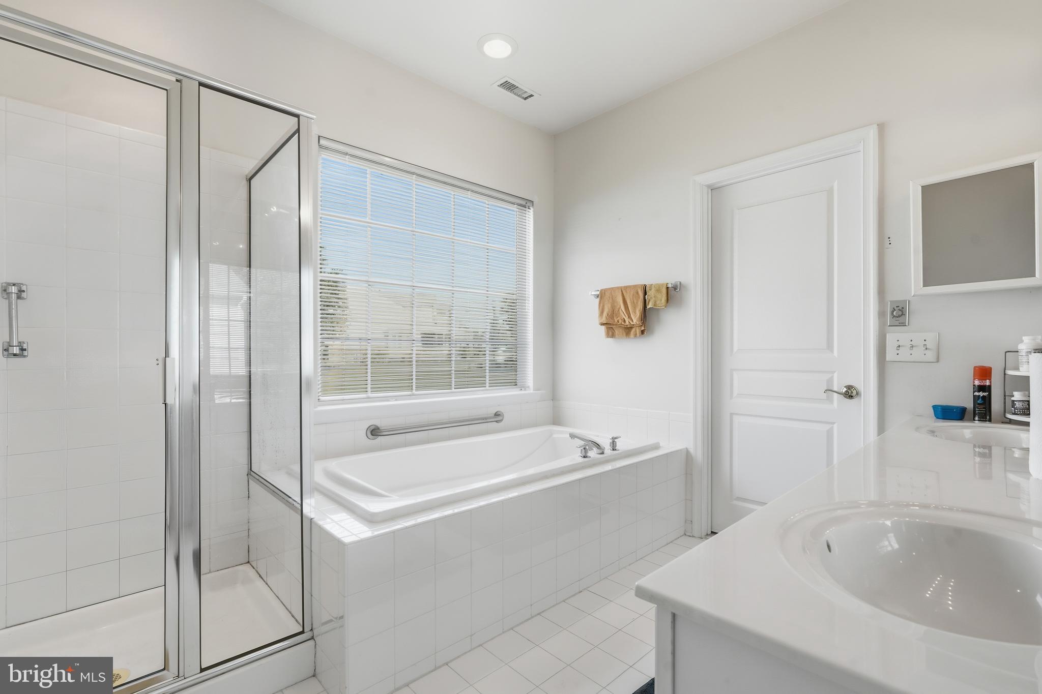 29 Pennington Court Delanco, NJ 08075 - Photo 25 of 57 a bathroom with a tub a sink and a large mirror