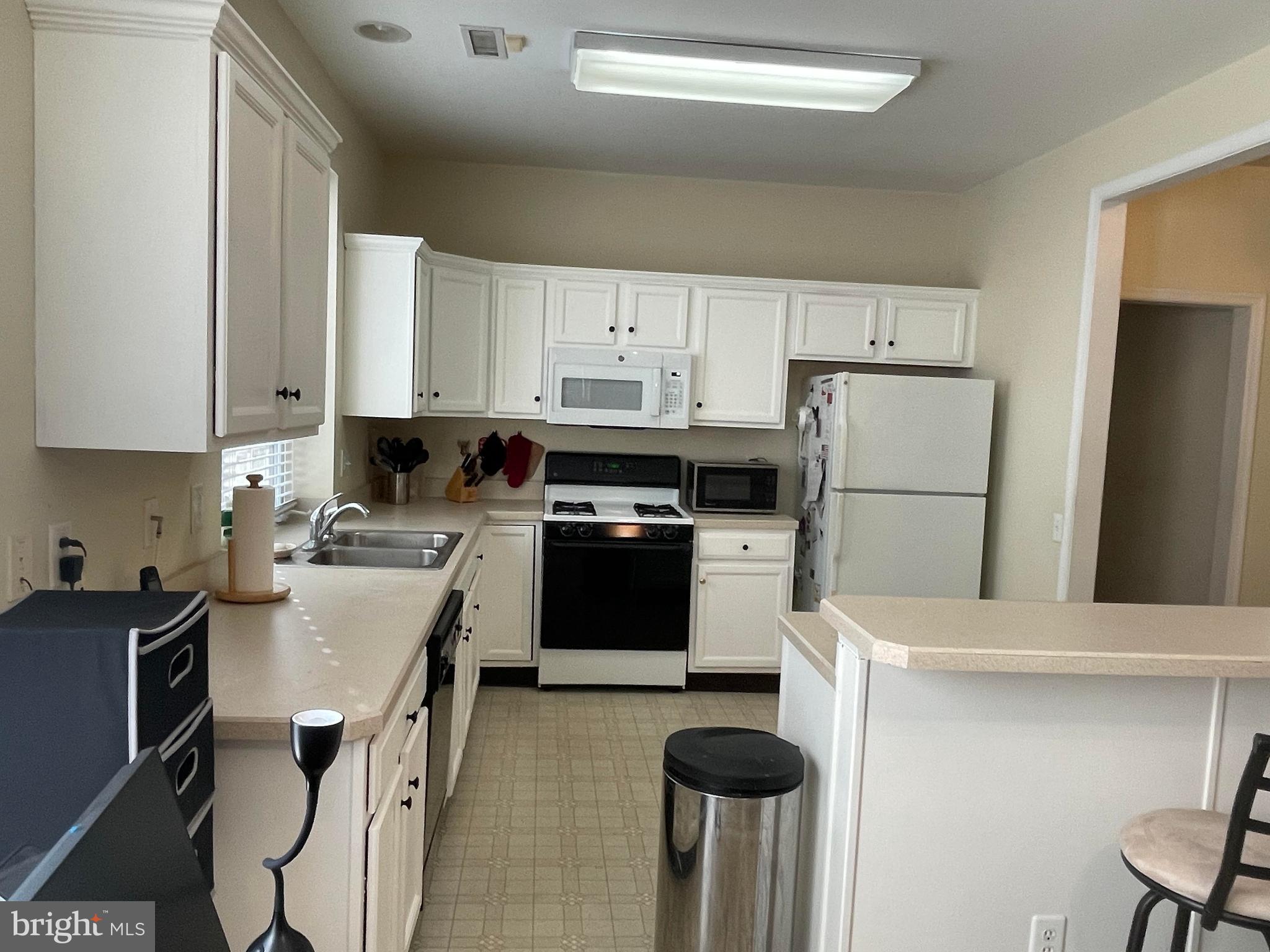 29 Pennington Court Delanco, NJ 08075 - Photo 9 of 57 a kitchen with a refrigerator a stove a sink and white cabinets