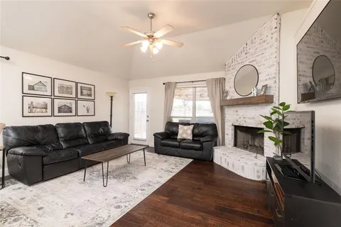 a living room with furniture a fireplace with wooden floor