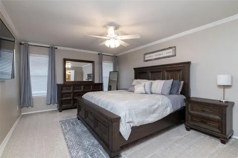 a bedroom with bed and a chandelier