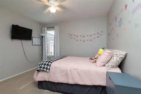 a bedroom with a bed and flat screen tv