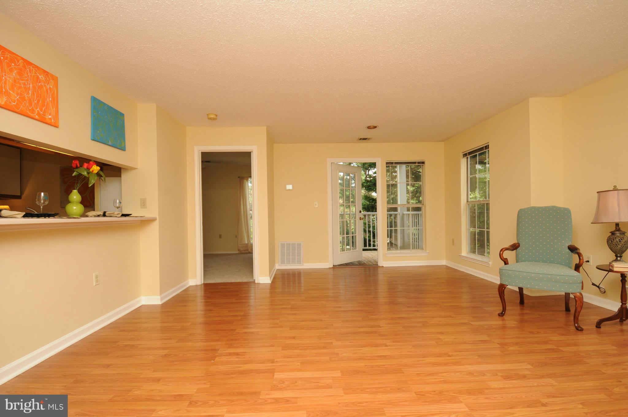 20985 Timber Ridge Terrace, Unit 204 Ashburn, VA 20147 - Photo 8 of 21 Living/Dining Room with Breakfast Bar