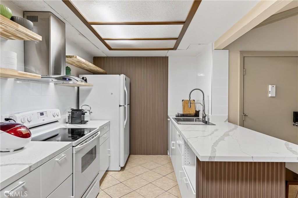 3535 Banbury Drive, Unit 14 Riverside, CA 92505 - Photo 12 of 17 a kitchen with stainless steel appliances granite countertop a sink stove and refrigerator