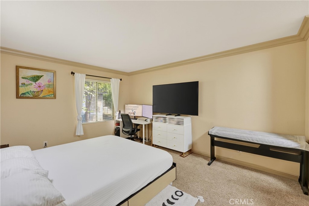 3535 Banbury Drive, Unit 14 Riverside, CA 92505 - Photo 13 of 17 a bedroom with a bed and a flat screen tv