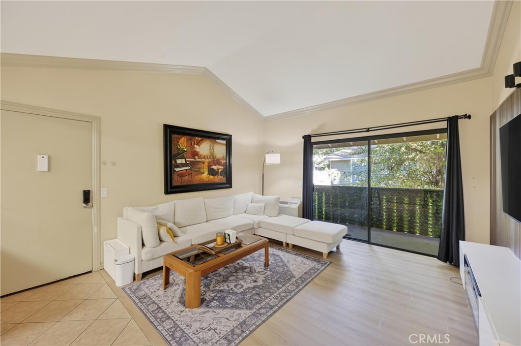 3535 Banbury Drive, Unit 14 Riverside, CA 92505 - Photo 3 of 17 a living room with furniture a large window and a rug