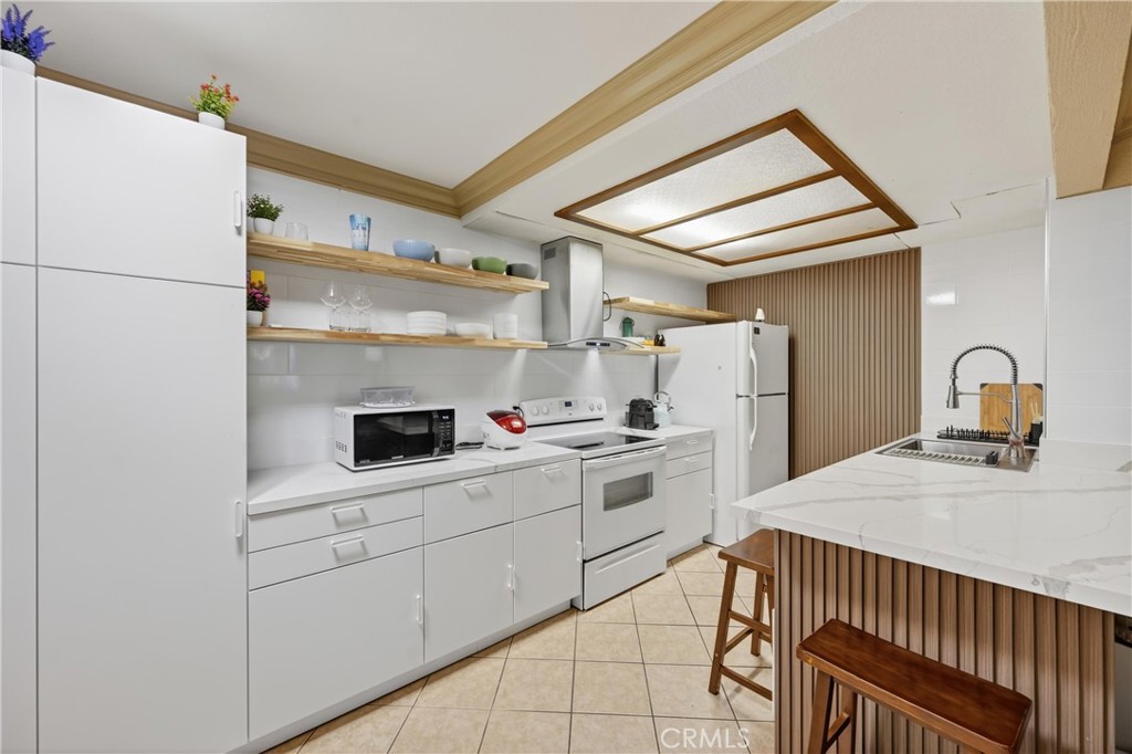 3535 Banbury Drive, Unit 14 Riverside, CA 92505 - Photo 8 of 17 a kitchen with appliances cabinets and a sink