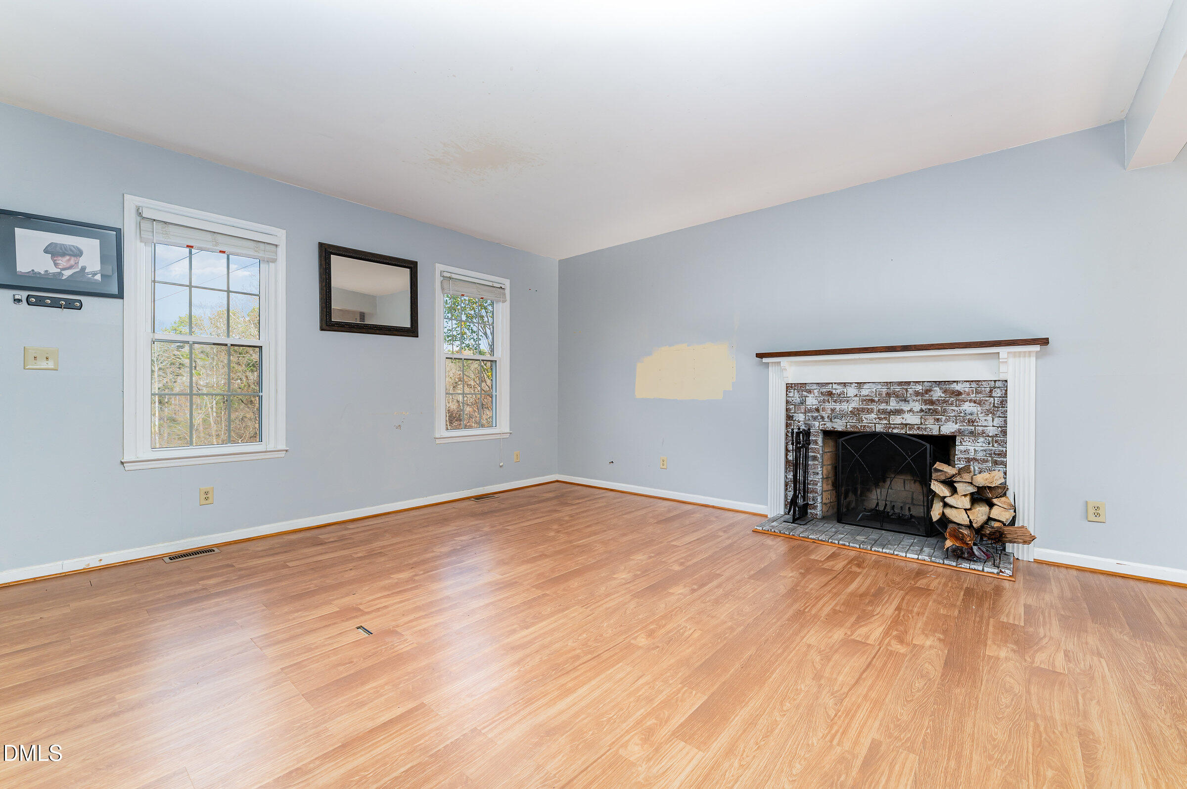 6205 Waterside Lane Raleigh, NC 27613 - Photo 10 of 40 a view of an empty room with a window and a fireplace
