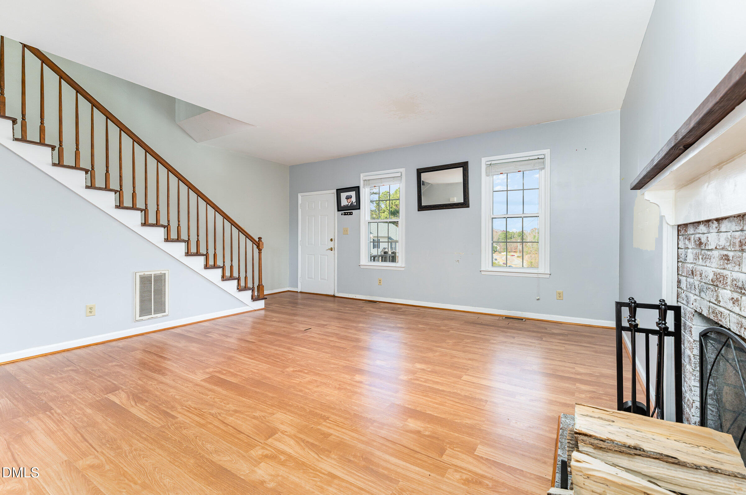 6205 Waterside Lane Raleigh, NC 27613 - Photo 14 of 40 a view of an empty room with wooden floor and a window