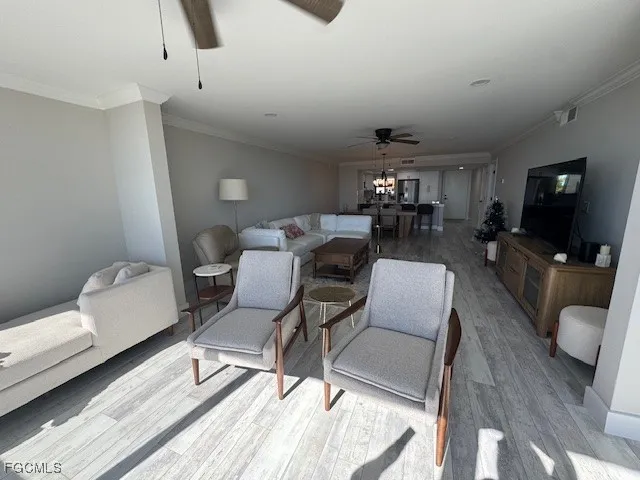 a living room with furniture a flat screen tv and a rug