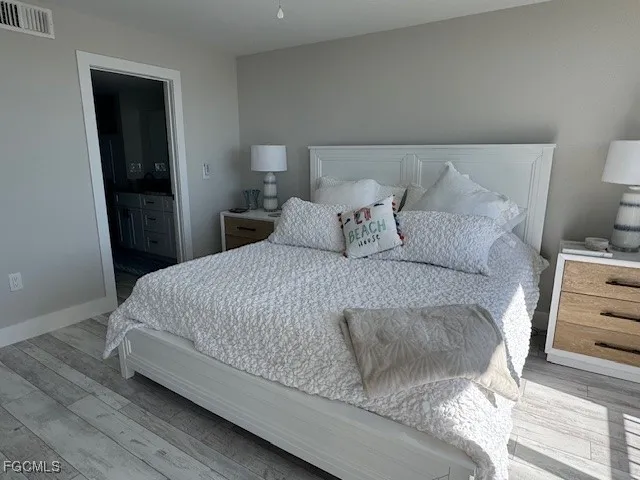 a large bed sitting in a bedroom next to a window
