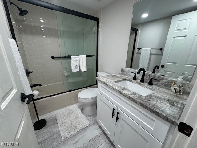15010 Punta Rassa Road, Unit 404 Fort Myers, FL 33908 - Photo 21 of 29 a bathroom with a granite countertop sink a toilet and a mirror