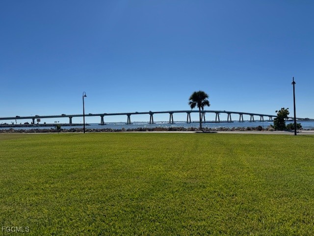 15010 Punta Rassa Road, Unit 404 Fort Myers, FL 33908 - Photo 24 of 29 a view of a swimming pool with a yard
