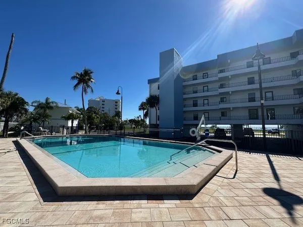 a view of a swimming pool with a patio and a garden