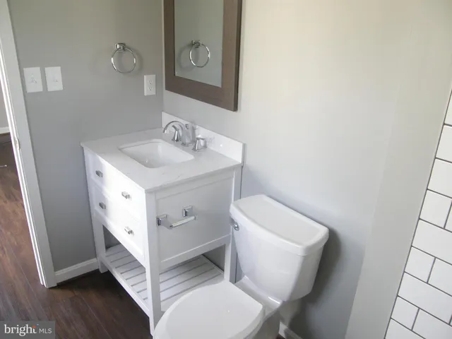 a bathroom with a sink vanity and mirror