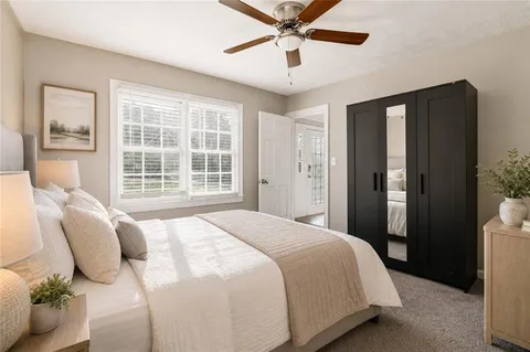 an empty room with a ceiling fan and wooden floor