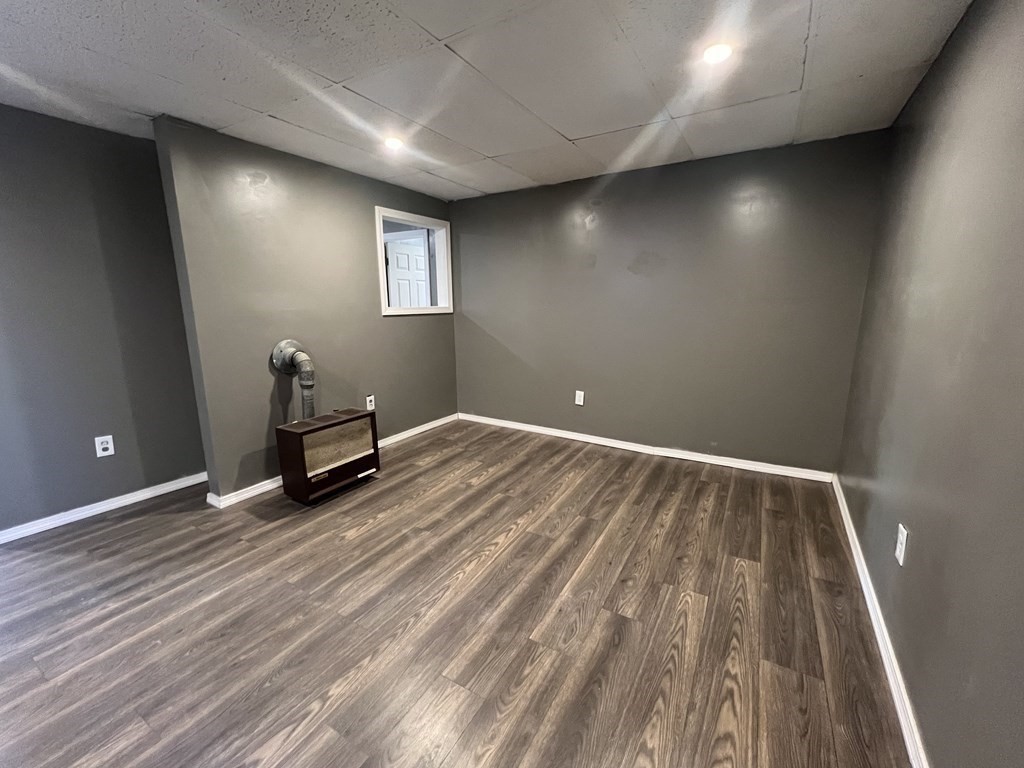 a view of room with wooden floor